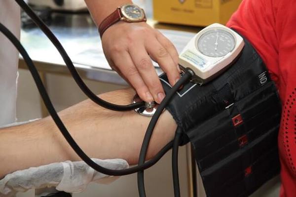 A nurse checking blood pressure