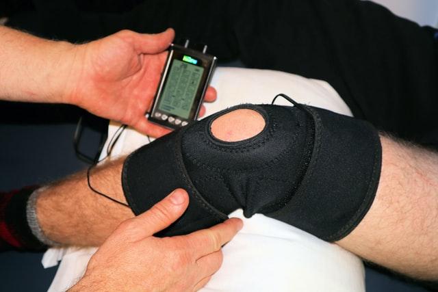 Physiotherapist treating a knee injury Electrotherapy