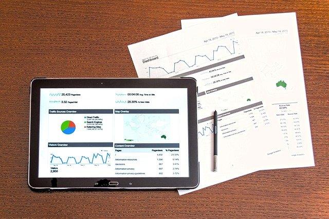 business data ipad showing data and paper with figures