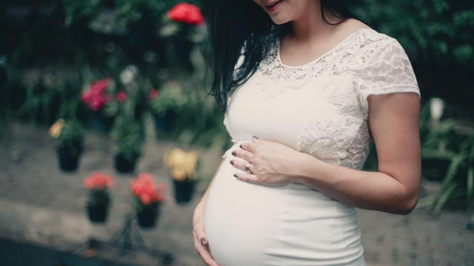 Pregnant woman holding tummy