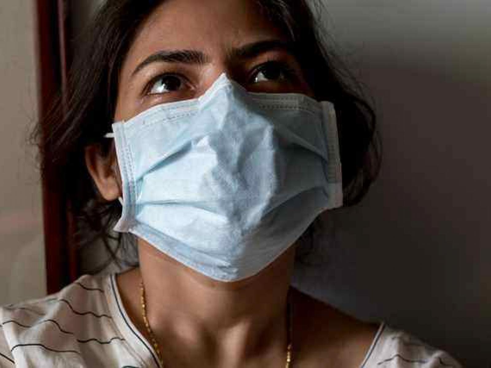 A female health professional wearing a mask